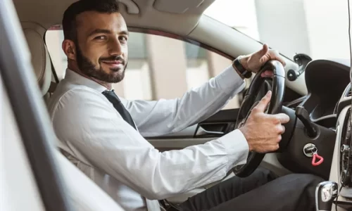 depositphotos_202264598-stock-photo-smiling-handsome-driver-holding-steering