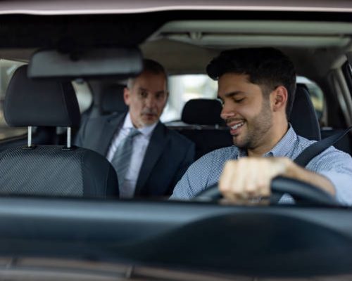 Passenger talking to his crowdsourced taxi driver in the car - transportation concepts