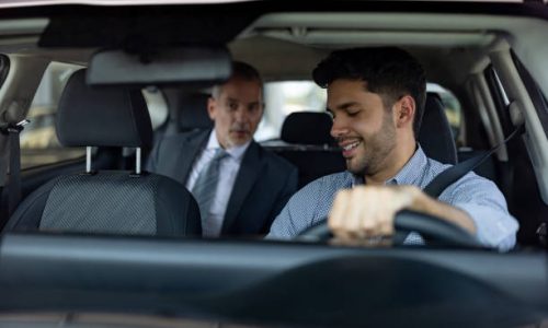 Passenger talking to his crowdsourced taxi driver in the car - transportation concepts